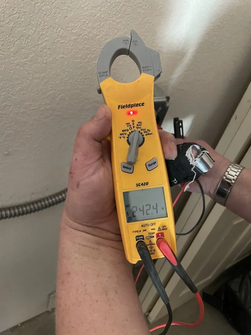 Voltage testing with clamp meter during Outlet Installation in Heartland